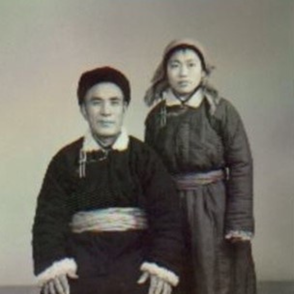 Black and white photo of a man and a woman posing in Mongolian traditional clothes